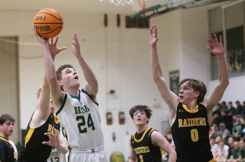 St. Bede's Phil Gray eyes the hoop while making his way into the lane as Ashton-Franklin Center's Aaron Lester defends during the Class 1A Regional quarterfinal game on Monday, Feb. 24, 2025 at St. Bede Academy.