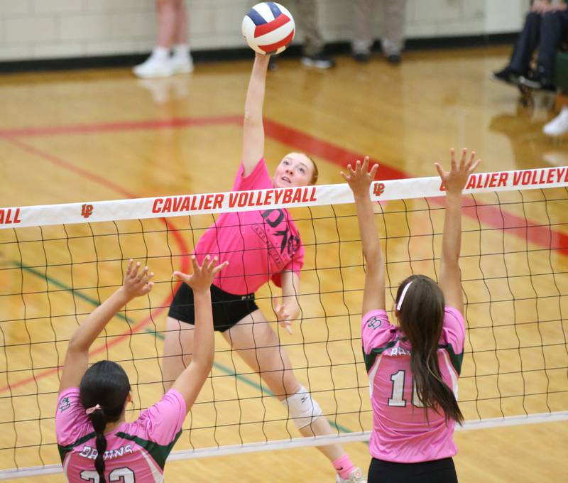 L-P's Katie Sowers sends a spike between St. Bede's Ali Bosnich and teammate Milana Gayan during the "Cavs 4 A Cause" pink night game on Tuesday, Sept. 26, 2023 at Sellett Gymnasium.