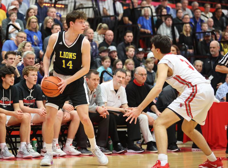 Lyons' Connor Carroll (14) looks for an outlet during the boys 4A varsity sectional semi-final game between Hinsdale Central and Lyons Township high schools in Hinsdale on Wednesday, March 1, 2023.