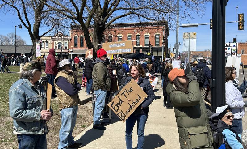 A demonstrator holds a sign at the No Kings rally on Saturday, March 28, 2026, in downtown Oregon, Illinois.