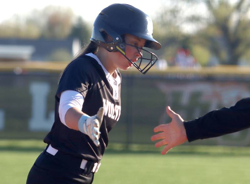 Prairie Ridge’s Autumn Ledgerwood is greeted as she arrives at first base with a single in varsity softball at Huntley High School in Huntley on Monday, May 5, 2025.