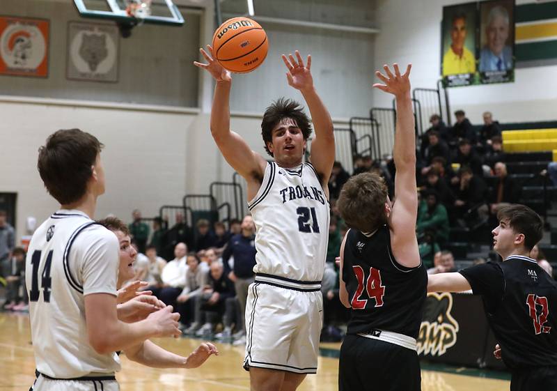 Cary-Grove's Brady Elbert passes the ball as her drives the lane against Marmion's Alex Eloe during an IHSA Class 3A Crystal Lake South Regional boys basketball semifinal game on Wednesday, February, 25, 2026, at Crystal Lake South High School.