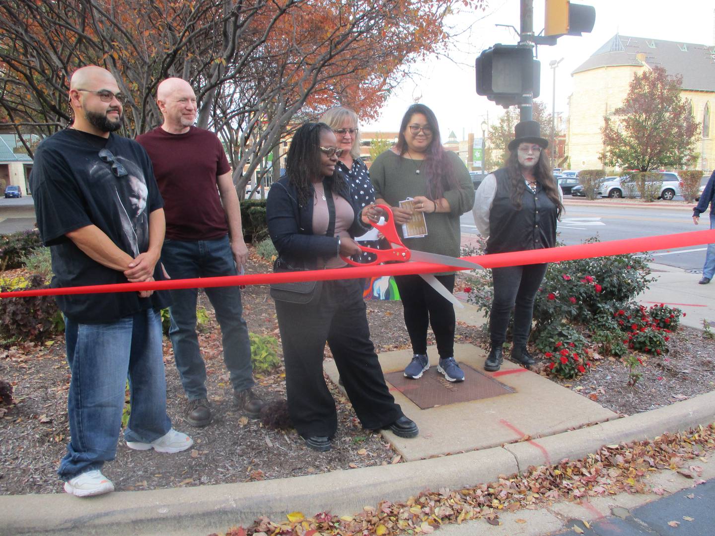 Six of the 10 artists who created artwork for the Downtown Music Box Project prepare to cut a ribbon for a ceremony for the project on Wednesday. They are (left to right) Rene Rodriguez, Dante DiBartolo, Donna Franks-Tapley, Margie Keniley, Sarah Comoda and Angelica Cristal. Oct. 30, 2024