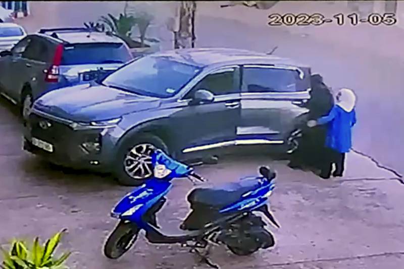 In this image from a store's security camera video, members of the Hijazi family get into a car in the Lebanese border village of Bilda, headed toward Beirut on Sunday, Nov. 5, 2023. (AP Photo)