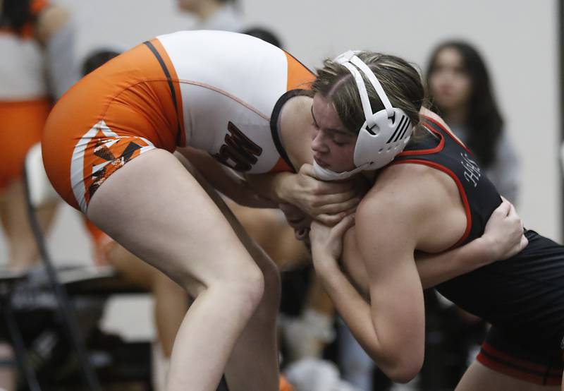 Huntley’s Aubrie Rohrbacher tries to control McHenry’s Mackensie Hendricks during the 130-pound match of a Fox Valley Conference girls wrestling match Thursday, Jan. 11, 2024, at McHenry High School.