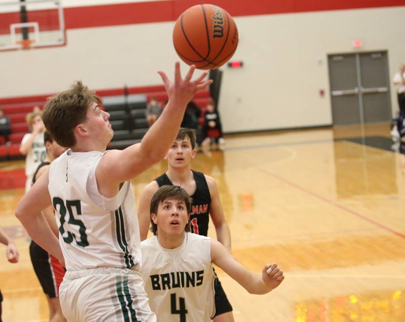 St. Bede's Jake Miglorini leaps in the air to hall in a rebound as teammate Logan Potthoff looks gets ready to grab it against Stillman Valley during the 49th annual Colmone Class on Thursday, Dec. 7, 2023 at Hall High School.