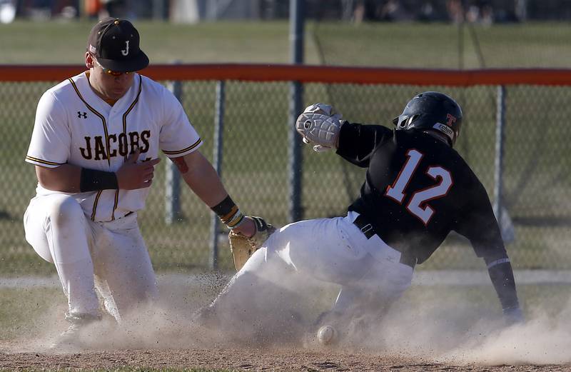Jacobs’ Paullie Rudolph tries to come up with the ball as Crystal Lake Central's Jaden Obaldo slides into third base during a Fox Valley Conference baseball game Monday, April 10, 2023, at Crystal Lake Central High School.
