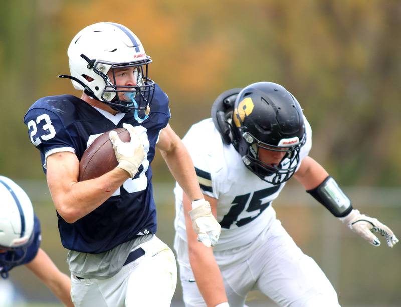 Cary-Grove’s Lance Moore gets past Sycamore’s Peter Gehrig in IHSA football Class 5A first-round playoff action at Al Bohrer Field on the campus of Cary-Grove High School in Cary on Saturday, November 1, 2025.