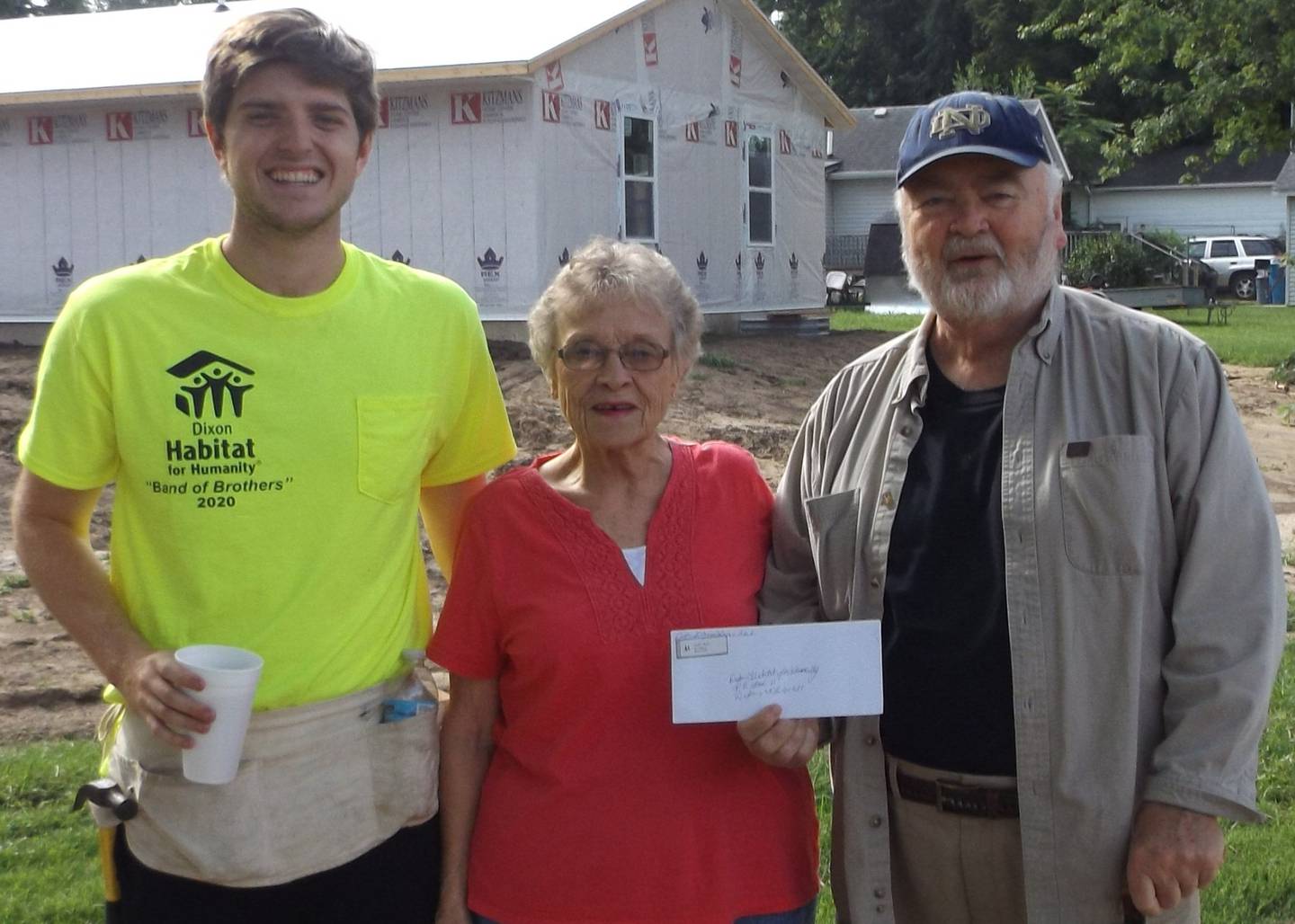 (Left to right); Dixon Habitat for Humanity volunteers Reagan Ballard and Jim Dixon receiving a $500 check donation from Dixon Lioness Club representative Gloria Schneider. The check will be put towards building this year's Habitat project.