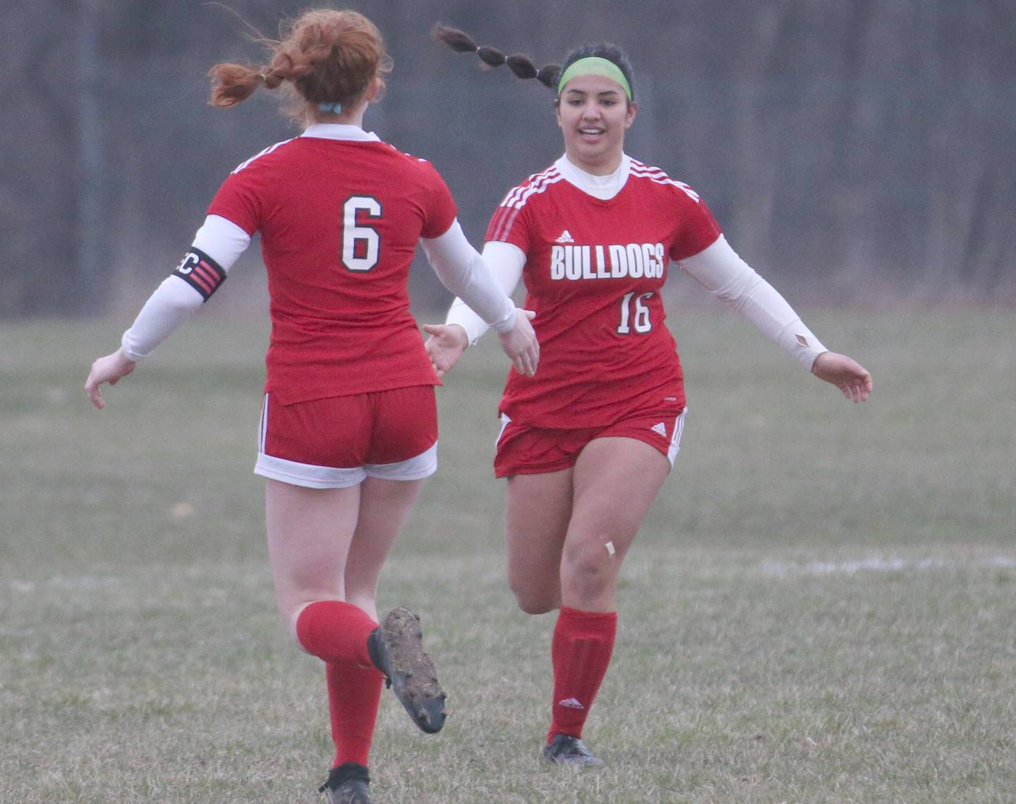 Streator's Ellie Isermann (6) congratulates teammate Zulima Gonzalez after Gonzalez scored the Bulldogs' second goal against L-P on Friday, March 24, 2023, at the Streator Family YMCA.