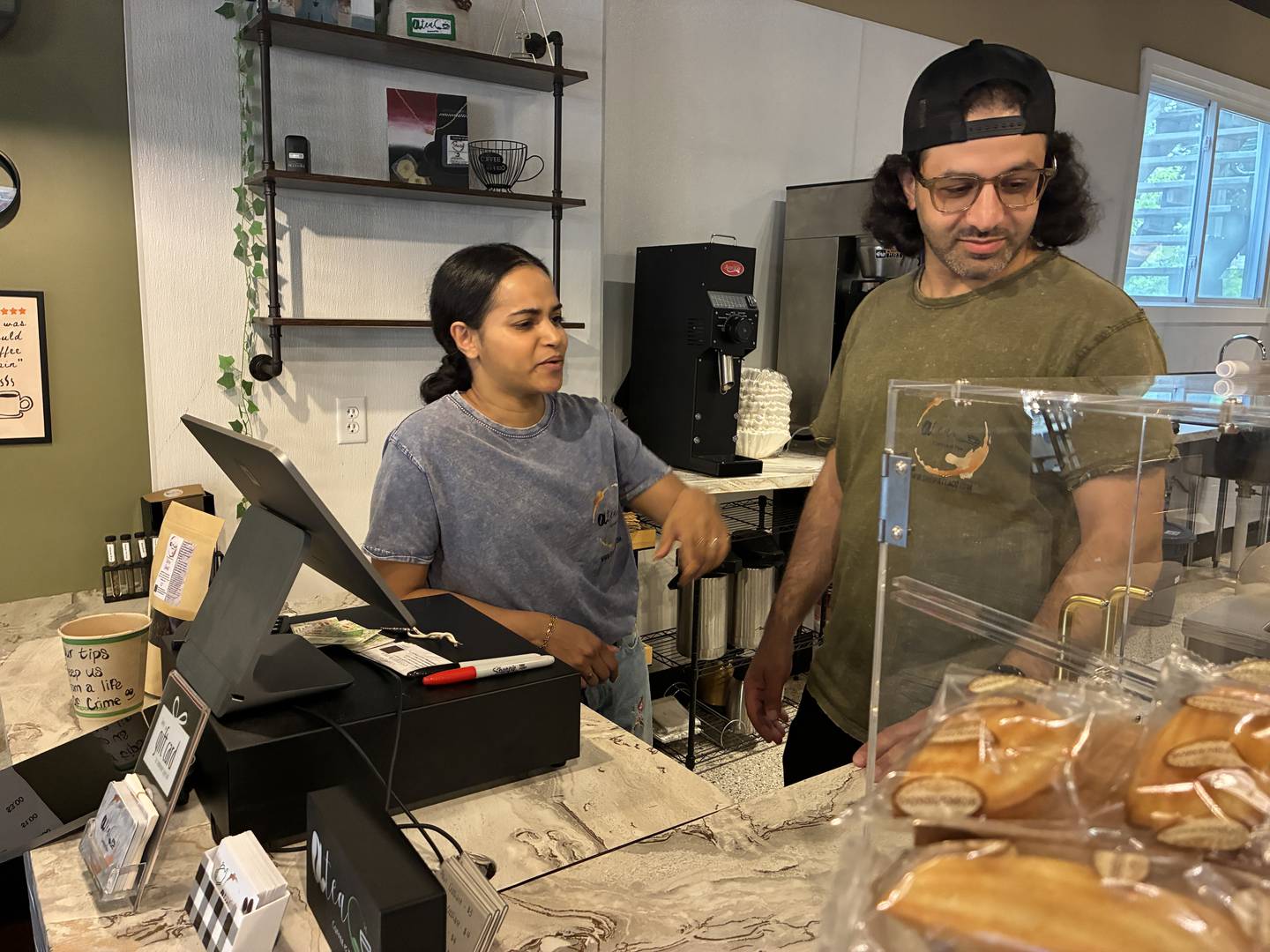 Neshwa Rajeh, left, and Atik Altahif, behind the counter at AteaCo, 1323 Riverside Drive. The couple had one of McHenry's Riverwalk Shoppes for the past two seasons and are now set to open a permanent location.