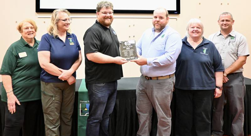Executive Director for the Illinois Conservation Foundation Steve Ettinger presents the award for favorite state park to Alvin Harper, Site Superintendent at the Illinois Department of Natural Resources on Friday at the Starved Rock visitors center.