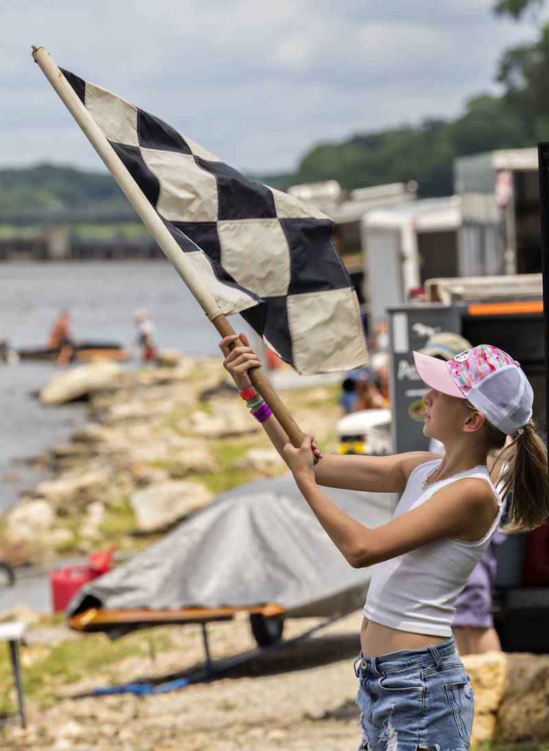 Jamie Hoffmann, 11, of Whitewater, Wis. waves the checkered flag Saturday, July 12, 2025, during the races in Rock Falls.