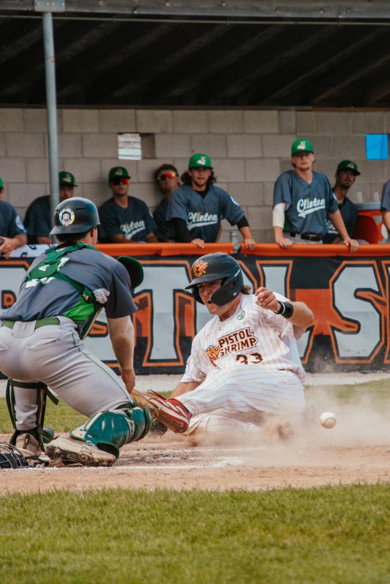 Pambos Nicoloudes slides into home during the Illinois Valley Pistol Shrimp's 11-10 win over the Clinton LumberKings on Wednesday, July 10, 2024 at Schweickert Stadium in Peru.