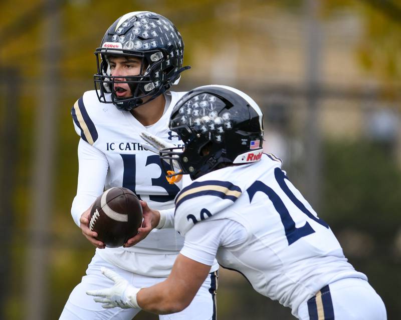 IC Catholic Prep's Nate Lang (13) hands the ball to teammate KC Kekstadt (20) during the 3A Playoff game against Chicago Hope Academy on Saturday Nov. 1, 2025, held at Altgeld Park in Chicago.