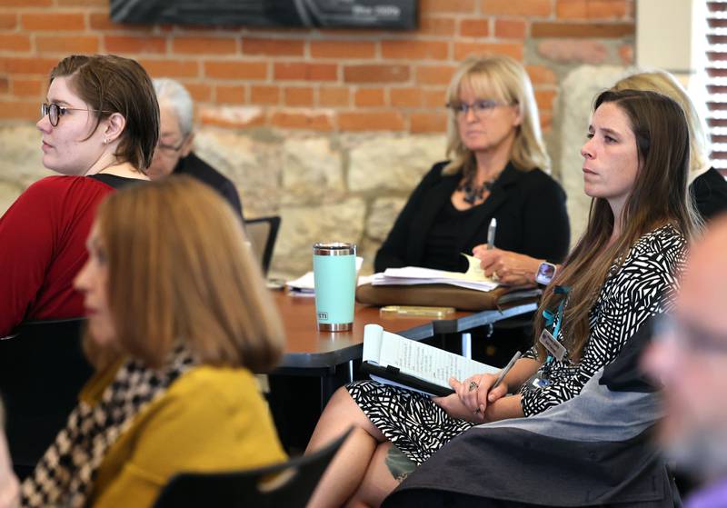 Attendees listen to the panel of law enforcement and judiciary members Wednesday, Sept. 13, 2023, during the Community Protection and Well-Being Forum: A Conversation about the Safe-T Act, in the DeKalb County Community Foundation Freight Room in Sycamore. The event was hosted by the Sycamore Chamber of Commerce.