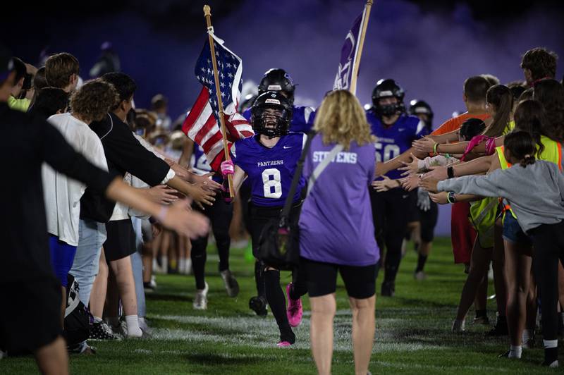 Manteno's Tyler Buehler leads the varsity football team onto the field before a game against Herscher on Friday, September 12, 2025.