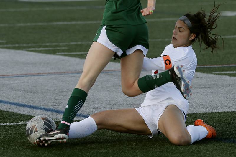 Huntley's Gabi Farraj slides as she kicks the ball away from Boylan Catholic's Brigid Donnellan during a nonconference soccer game on Wednesday, March 27, 2024, at Huntley High School.