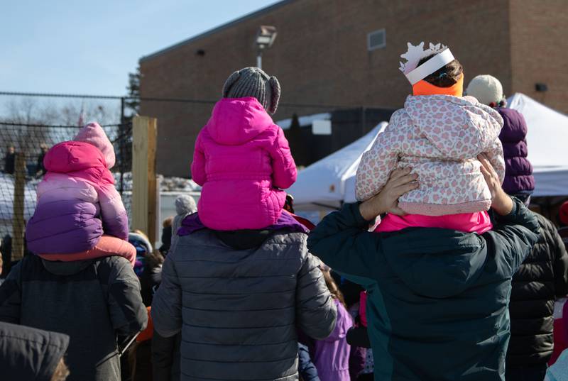 Attendees hold up their children to watch the performance by the Snow Princess and Ice Queen during the Wheaton Park District's Ice-A-Palooza at the Central Athletic Complex in Wheaton on Saturday, Feb. 4, 2023.
