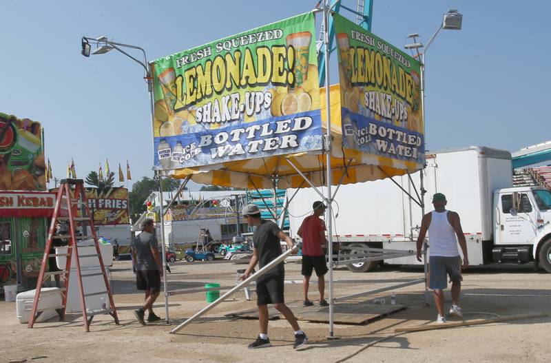 North American Midway Entertainment carnival workers set up a ride for the 168th annual Bureau County Fair on Tuesday, Aug. 22, 2023 in Princeton. The fair runs Wednesday through Sunday.