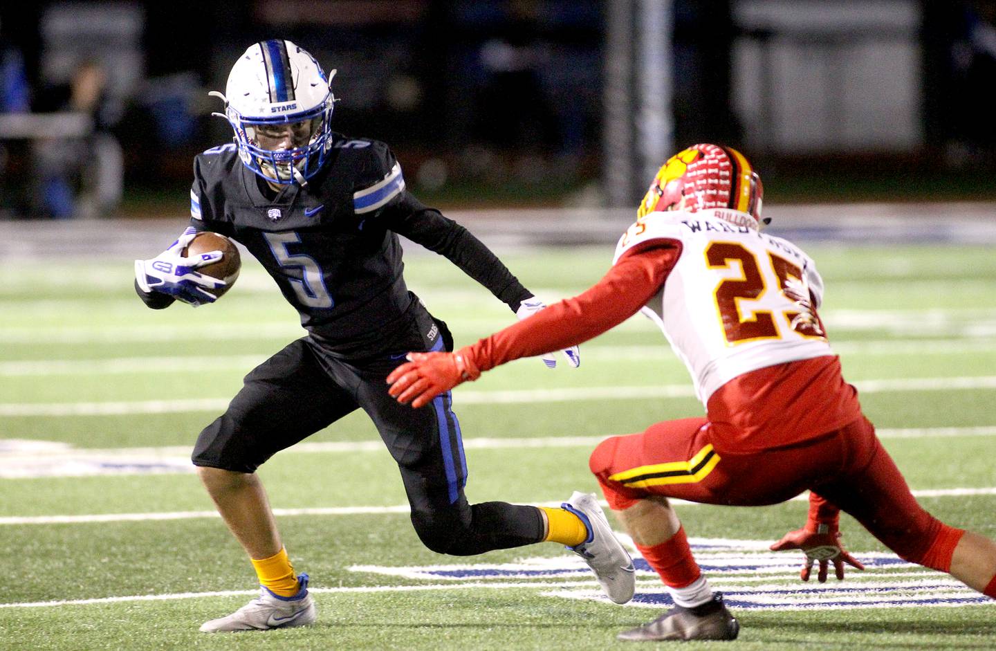 St. Charles North's Anthony Taormina (5) is stopped by Batavia's Grant Wardynski during a game at St. Charles North on Friday, Oct. 22, 2021.