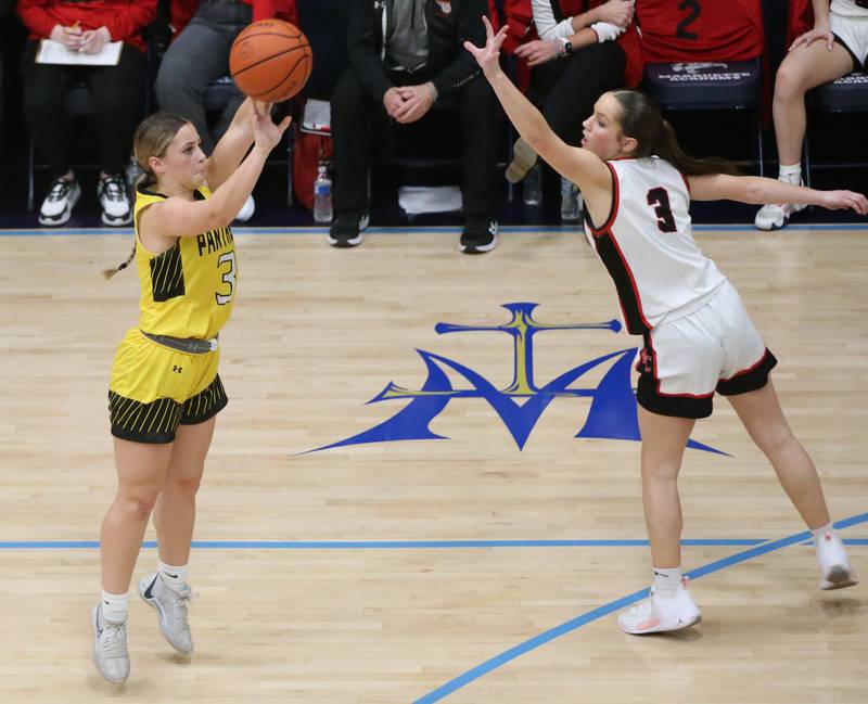 Putnam County's Gabby Doyle sinks a three point basket over Amboy's Elly Jones during the Class 1A Regional semifinal game on Monday, Feb. 12, 2024 at Marquette High School.