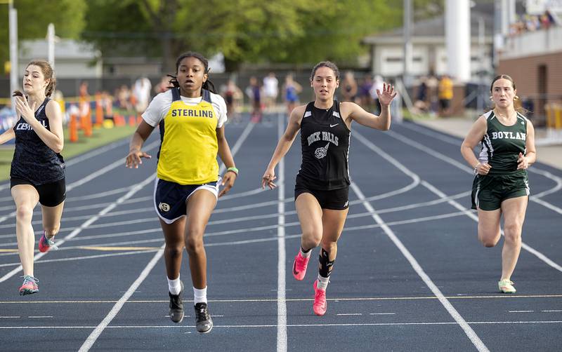 Sterling’s Taah Liberty (left) and Rock Falls’ Carli Kobbeman cross the finish neck and neck in the 100 dash Thursday, May 11, 2023 at the class 2A Sterling girls track sectionals.