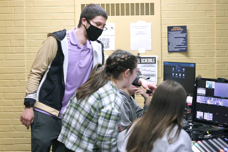 Educator Gregory D'Addario, (left) who teaches TV production and english at Sycamore High School, helps students in the control room during a taping Wednesday, March 1, 2023, at the school.