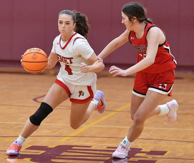 Benet’s Ava Mersinger (4) drives as Marist’s Grace Harmon defends during the Montini Christmas Tournament championship game on December 27, 2025 at Montini Catholic High School in Lombard.