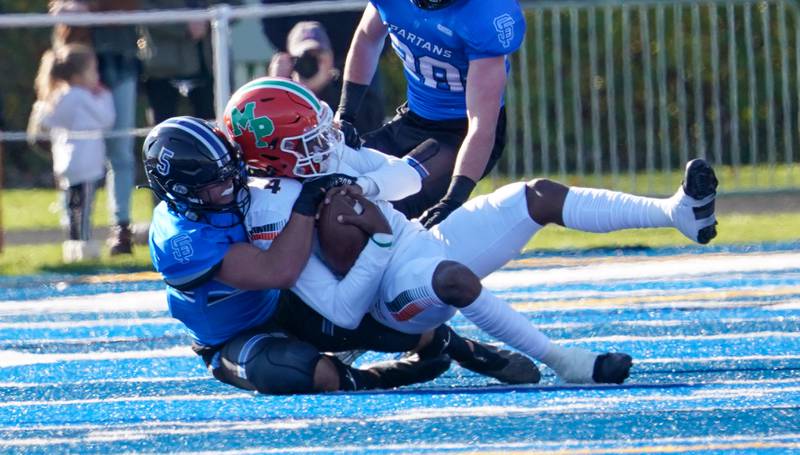 St. Francis' Dom Beres (5) sacks Morgan Park's Marcus Thaxton (4) for a loss during a class 5A state quarterfinal football game at St. Francis High School in Wheaton on Saturday, Nov 11, 2023.