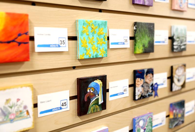 Art work done on small canvasses by early childhood students through adults is on display at the Westmont Public Library.