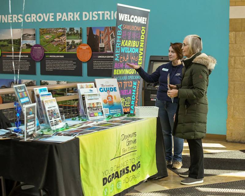 Dawn Hartman, left, of the Downers Grove Park District talk with Barbara Wood on Saturday Jan. 11, 2025, with programs they offer during the FitFest event held at the Downers Grove Park District recreation center.