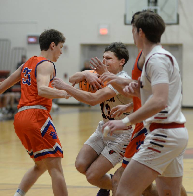 Forreston's Kendall Erdmann (13) draws a crowd as he drives the lane against Eastland on Saturday, Jan. 4, 2025 at Forreston High School.