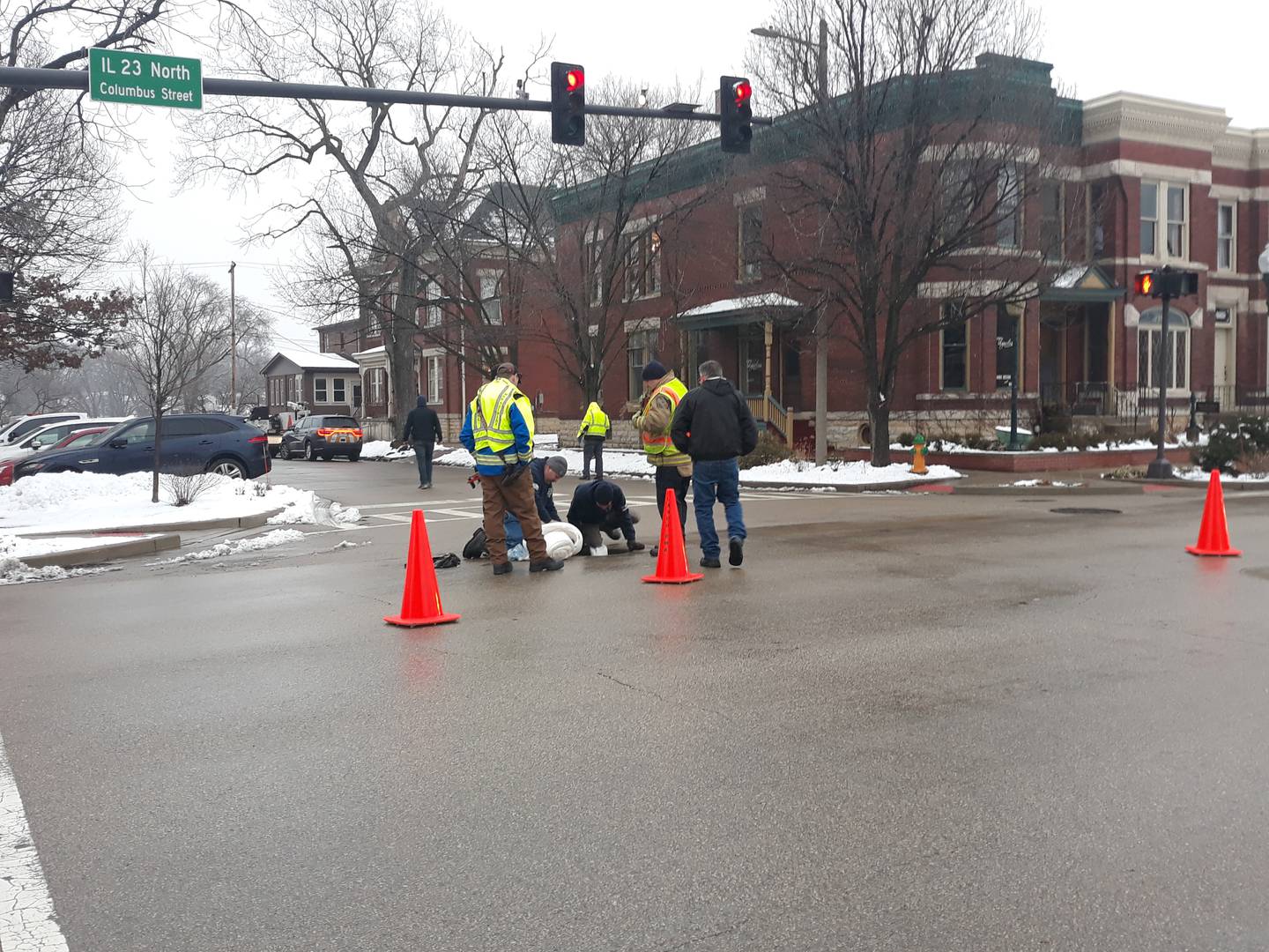 Crews work inside a manhole Wednesday, Jan. 25, 2023, at the corner of Jefferson and Columbus streets in Ottawa on what appeared to be a fuel spill through Ottawa's storm sewer system into the Fox River.