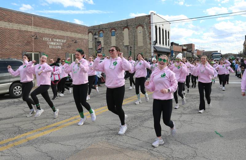 Girls from the Dance Center in La Salle run down Mill Street during the St. Patrick's Day parade on Saturday, March 16, 2024 downtown Utica.