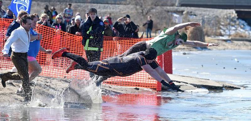 Participants race to the icy waters of Nippersink Lake to take part in Sunday's Fox Lake Polar Plunge for Special Olympics.