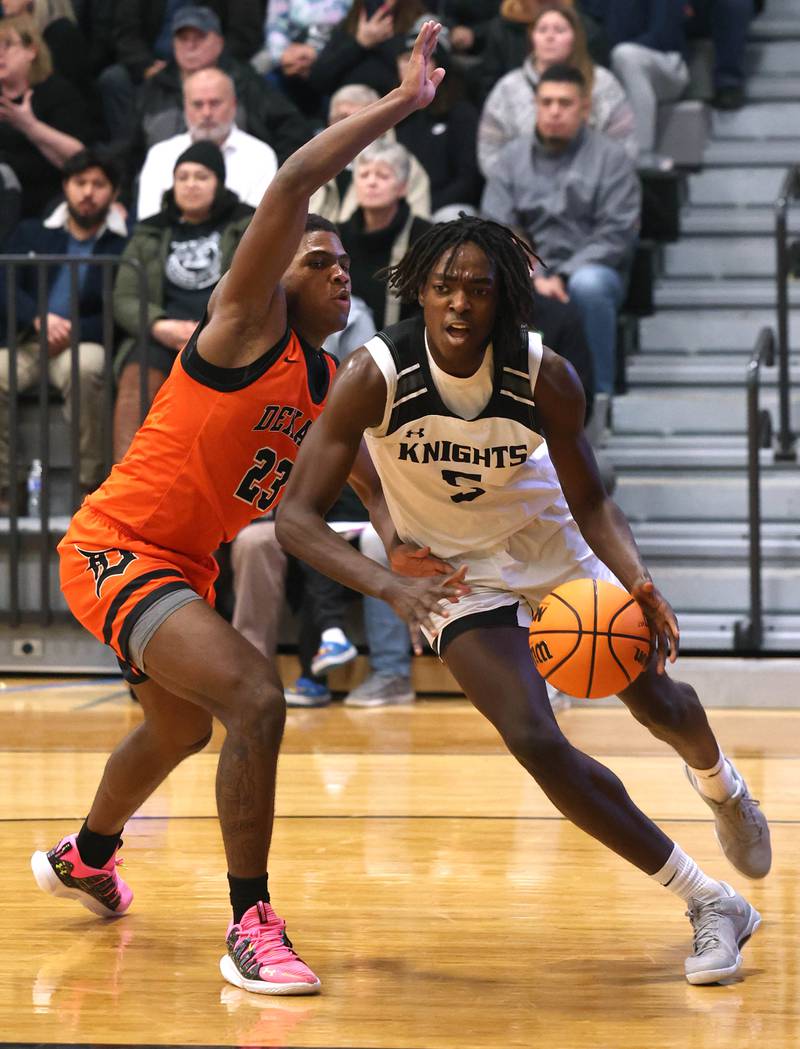Kaneland's Fredrick Hassan goes baseline against DeKalb's Davon Grant during their game Tuesday, Jan. 28, 2025, at Kaneland High School in Maple Park.