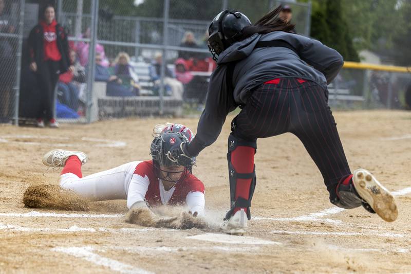Fulton’s Zoe Kunau is tagged out at home by Amboy’s Tyrah Vaessen Wednesday, May 21, 2025, during a Regional semifinal softball game.