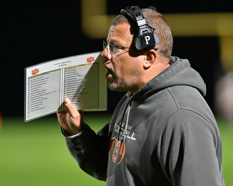 Crystal Lake Central head coach Dirk Stanger calls in a play during their Fox Valley Conference game against Hampshire on Friday, Oct. 20, 2023 in Crystal Lake.