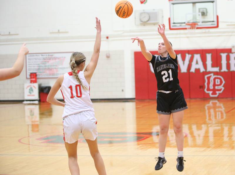 Kaneland's Kyra Lilly lets go of a three-point basket over L-P's Kelsey Frederick on Wednesday, Jan. 15, 2025 in Sellett Gymnasium at L-P High School.
