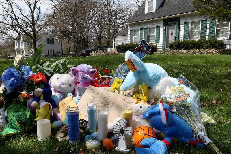 A makeshift memorial of stuffed animals, candles, and well-wishes sits near the sidewalk in front of the Freund residence on Dole Ave on Monday in Crystal Lake.