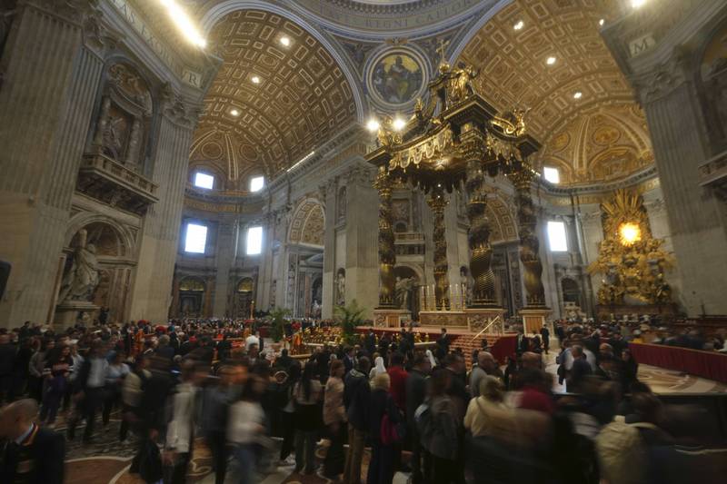 Faithful pay their respect to Pope Francis lying in state inside St. Peter's Basilica, at the Vatican, Friday, April 25, 2025. (AP Photo/Alessandra Tarantino)