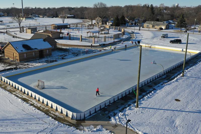 Kids skate and play hockey on the ice rink in Washington Park on Wednesday, Feb. 1, 2023 in Peru.