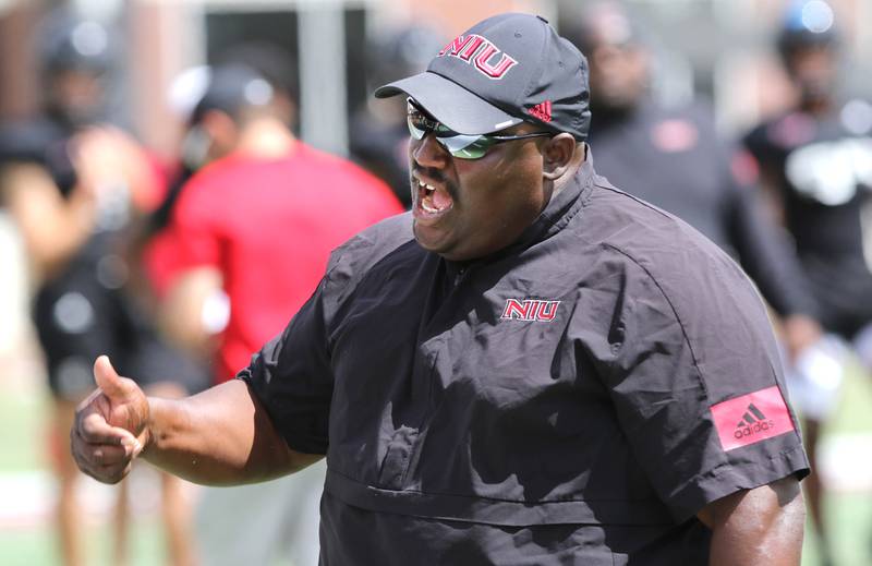 Northern Illinois Huskies head football coach Thomas Hammock makes a point with a player Tuesday, Aug. 9, 2022, during practice in Huskie Stadium at NIU.