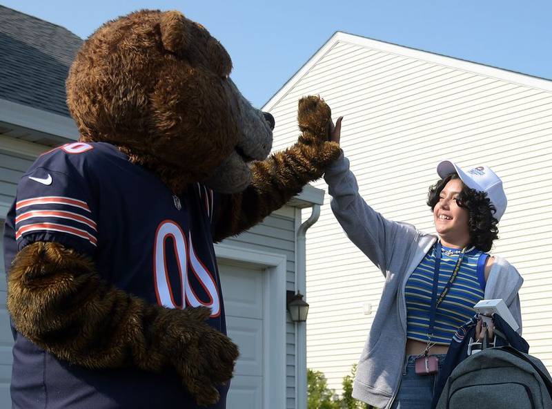 Kaylah Gonzalez gets a high-five Wednesday from Staley Da Bear after the Chicago Bears and Advocate Children's Hospital surprised Gonzalez with a trip to Green Bay to see the Bears play the Packers at Lambeau Field.