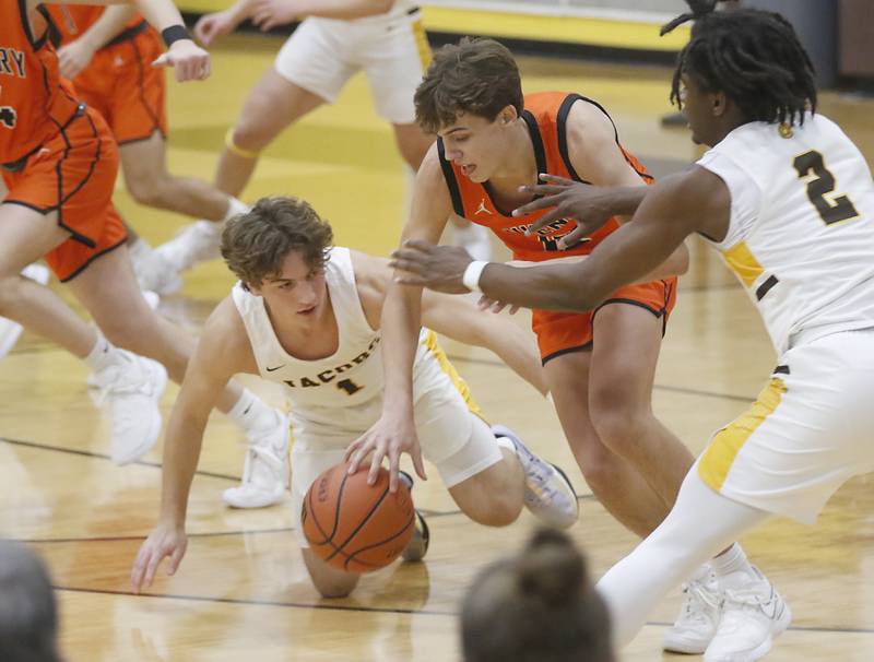 McHenry's Caleb Jett controls the ball between Jacobs' Ben Jurzak and Treval Howard during a Fox Valley Conference boys basketball game on Wednesday, Nov. 29, 2023, at Jacobs High School in Algonquin.