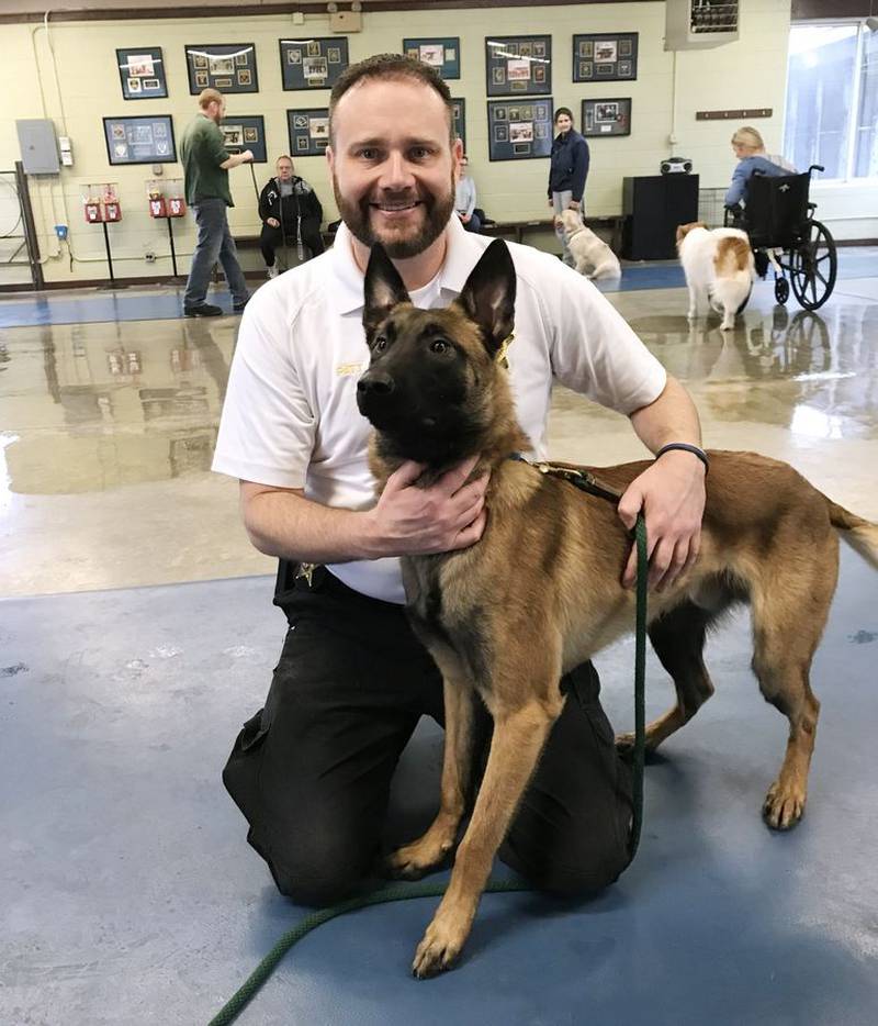 Former Chief Deputy Coroner Jason Patt poses with Bones, a Belgian Malinois, in this photo taken when the pair were being trained together in 2018. Patt filed a lawsuit Thursday alleging that Lake County Coroner Jennifer Banek blacklisted him after he declined to return the dog to the office when Patt resigned and Bones retired in 2020.