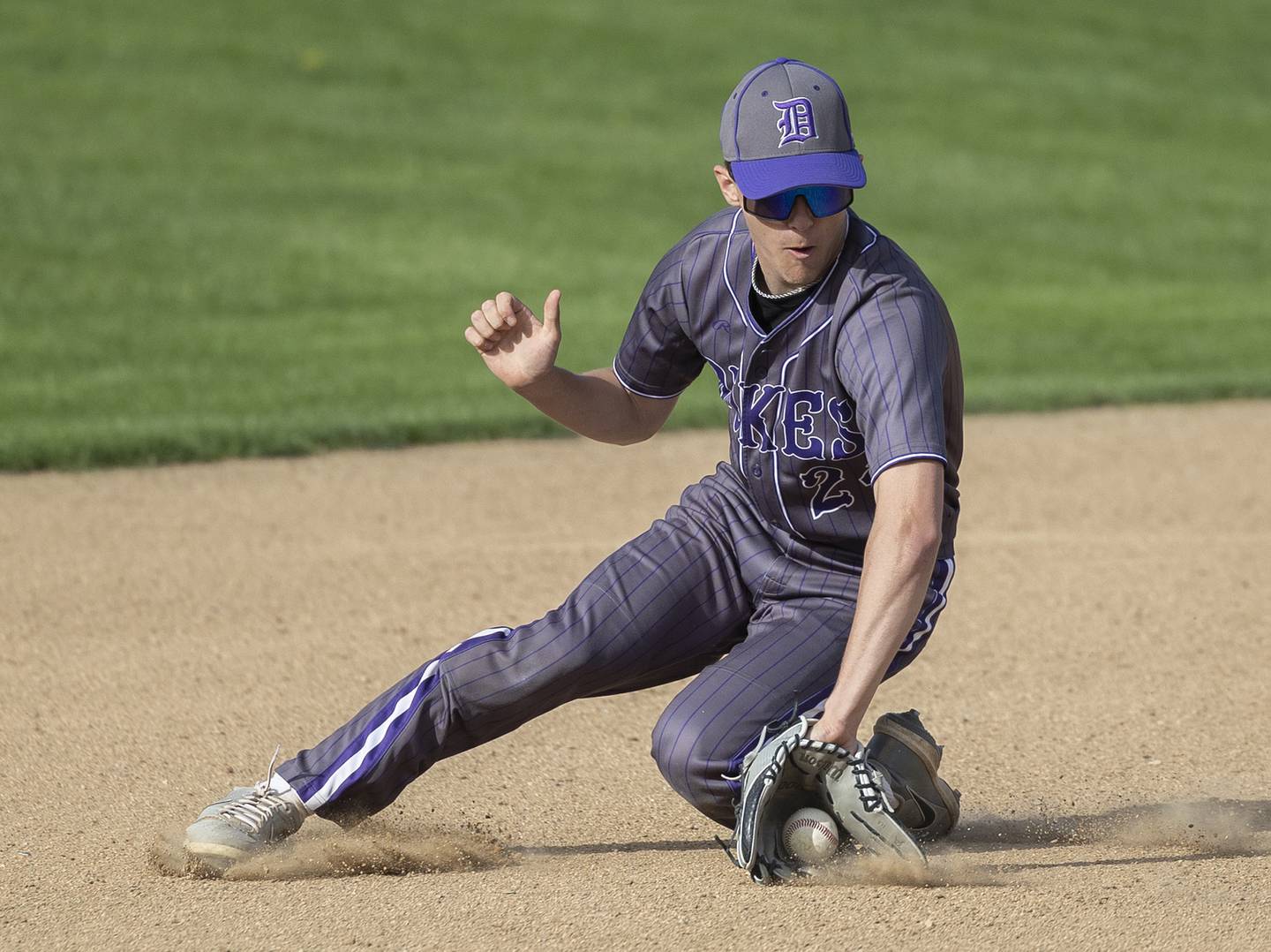 Dixon’s Brady Feit makes a sliding stop at short against Rock Falls Tuesday, April 29, 2025.