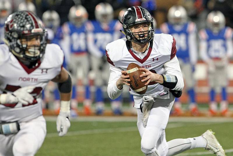 Plainfield North quarterback Brady Miller moves out of the pocket in the second quarter against East St. Louis in the Class 7A state football final Saturday.