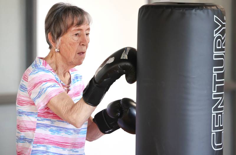Jan Edwards hits the bag Friday, April 28, 2023, during Rock Steady Boxing for Parkinson's Disease class at Northwestern Medicine Kishwaukee Health & Wellness Center in DeKalb. The class helps people with Parkinson’s Disease maintain their strength, agility and balance.